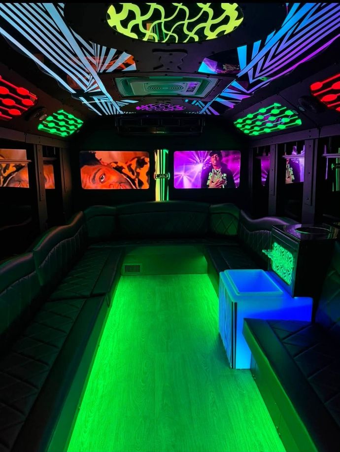 Neon-lit lounge interior with glowing green floor, colorful ceiling lights, and dark seating booths