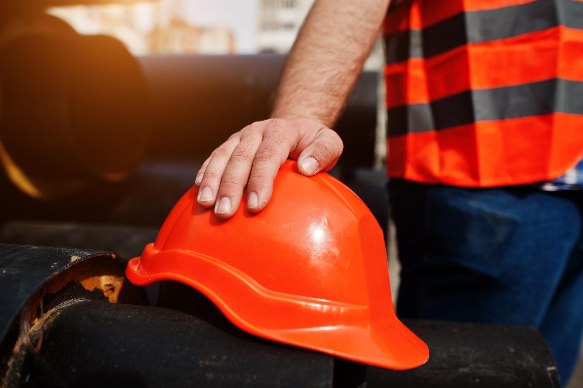 Construction worker with orange vest and helmet 