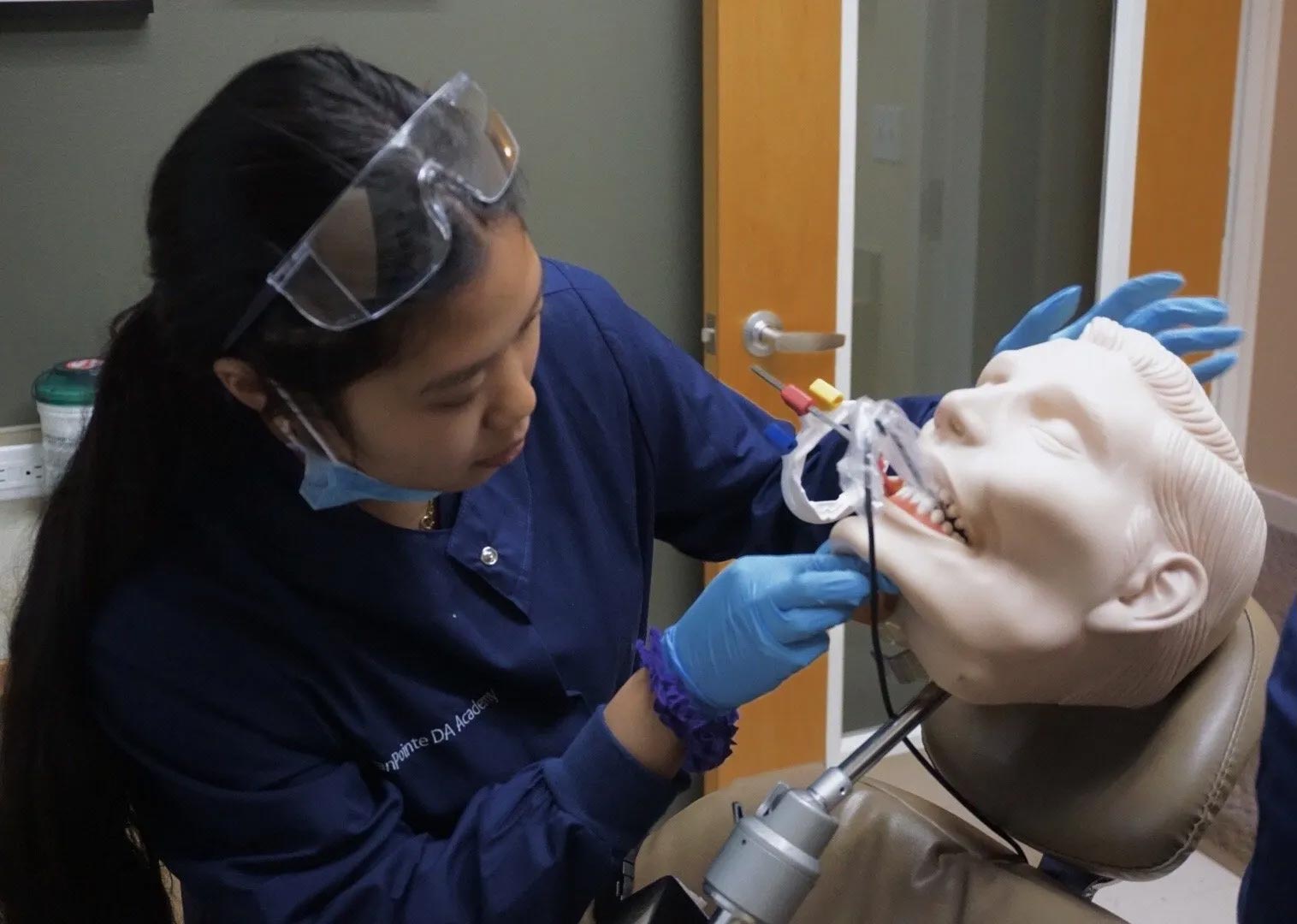 A Dental Assisting learning to take x-rays