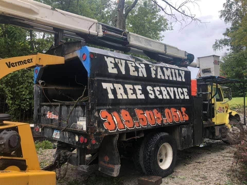 Ever Family Tree Service truck with cherry picker beside a house on a wooded driveway