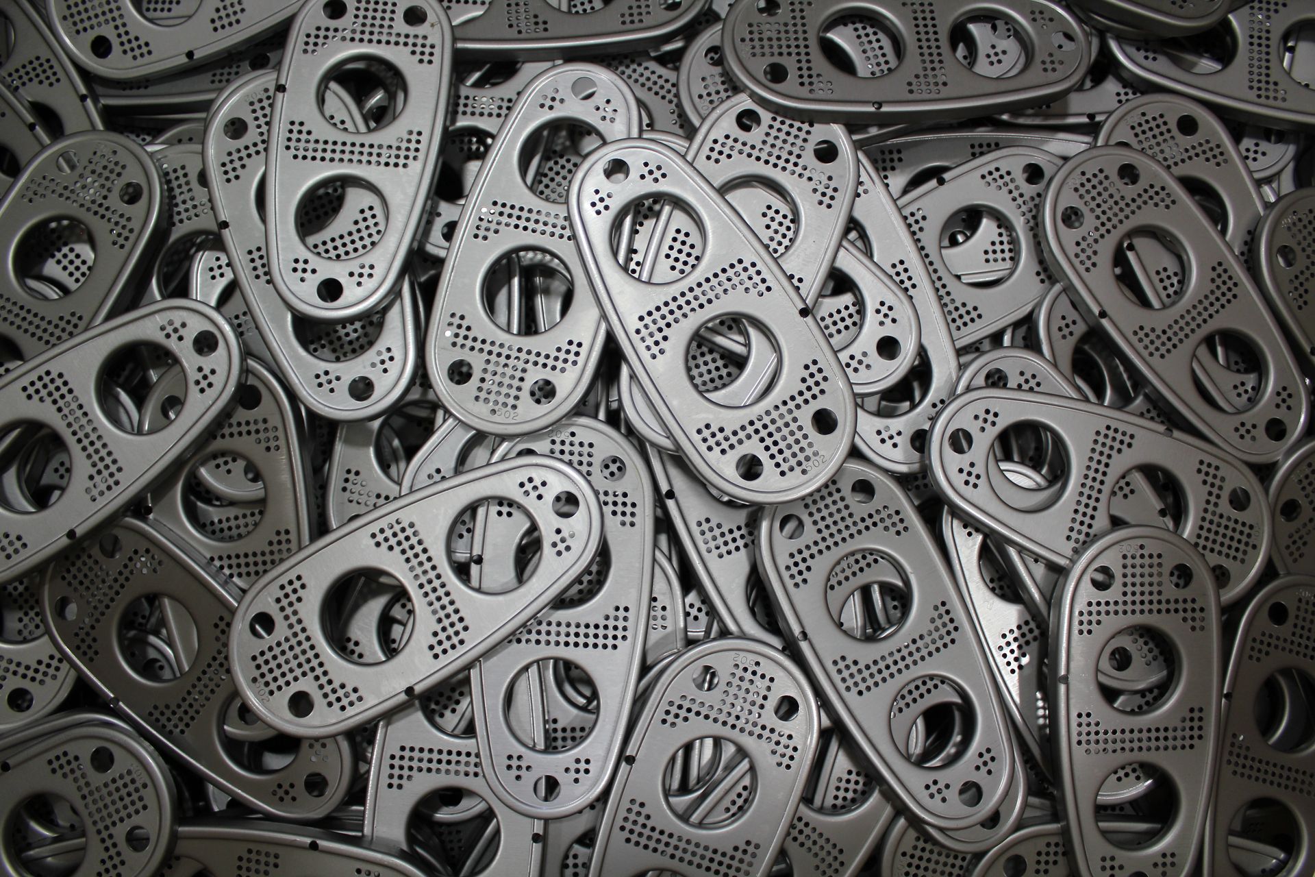 A pile of metal pieces with holes in them.