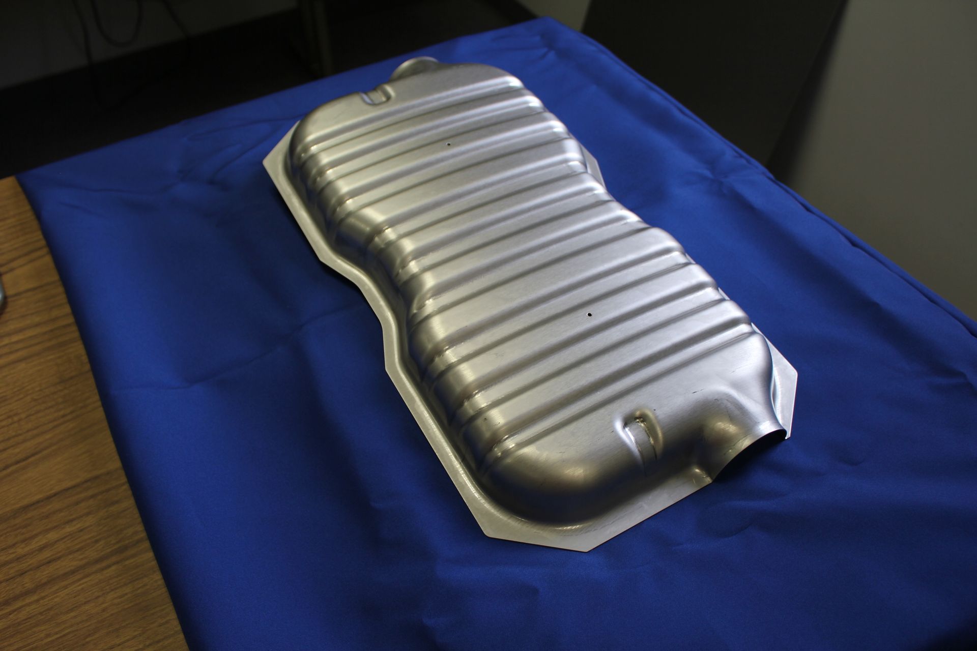 A metal object is sitting on a blue cloth on a table
