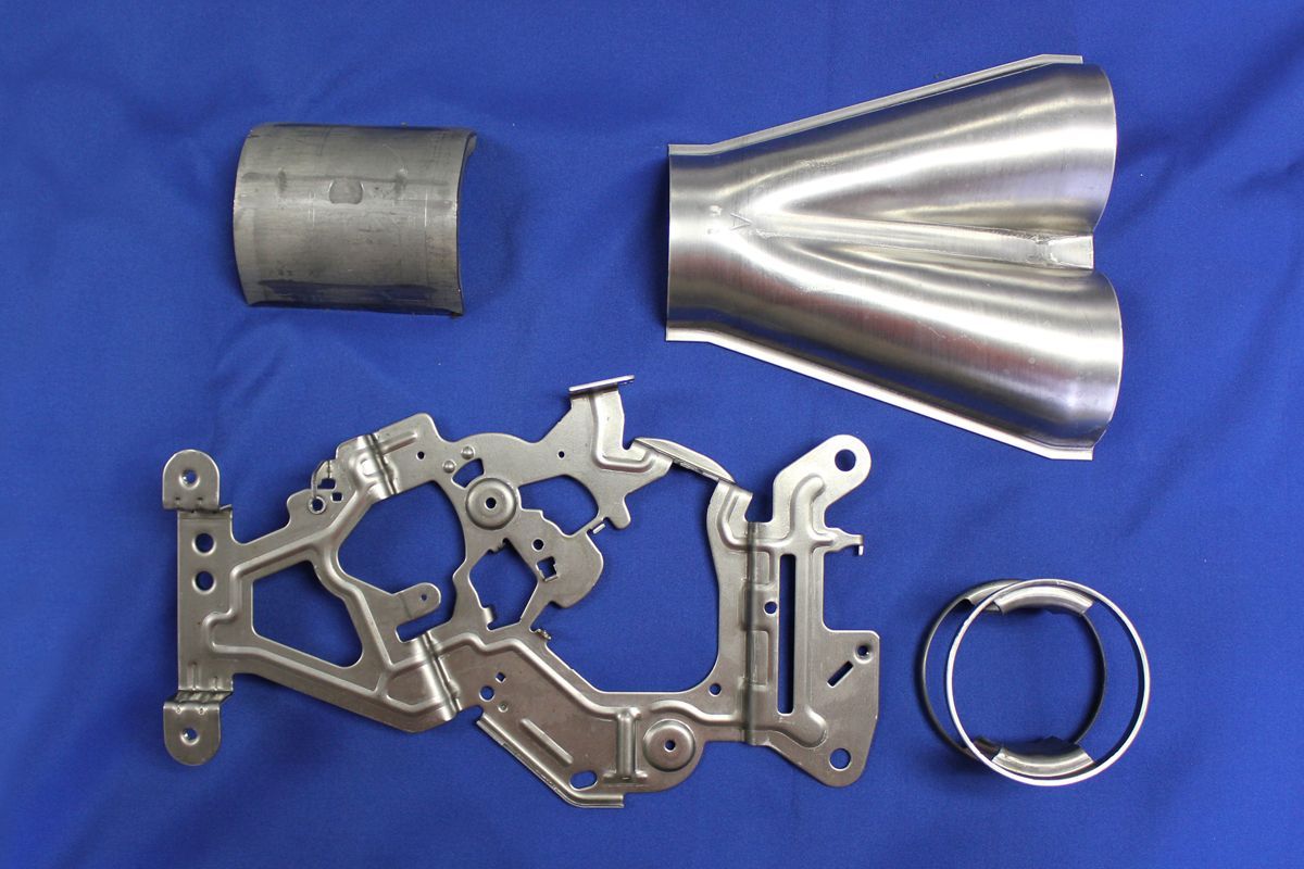 A bunch of metal parts are laying on a blue cloth