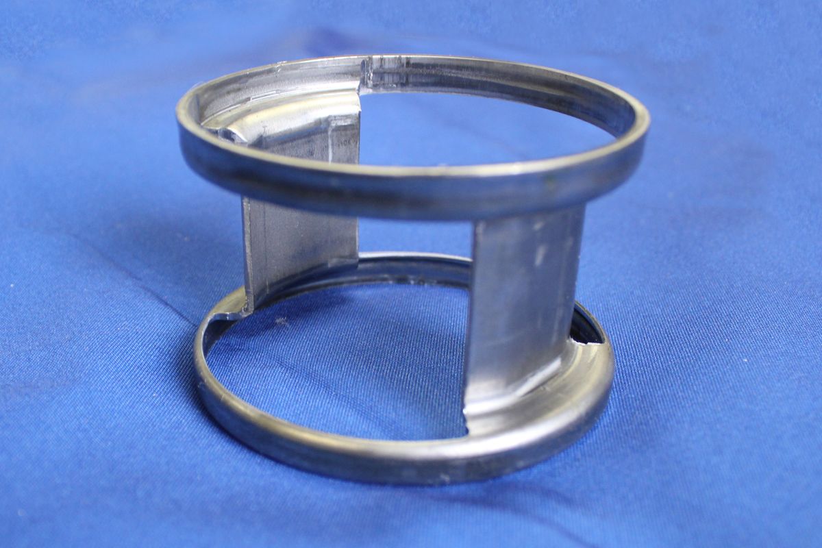 A metal object is sitting on a blue cloth.