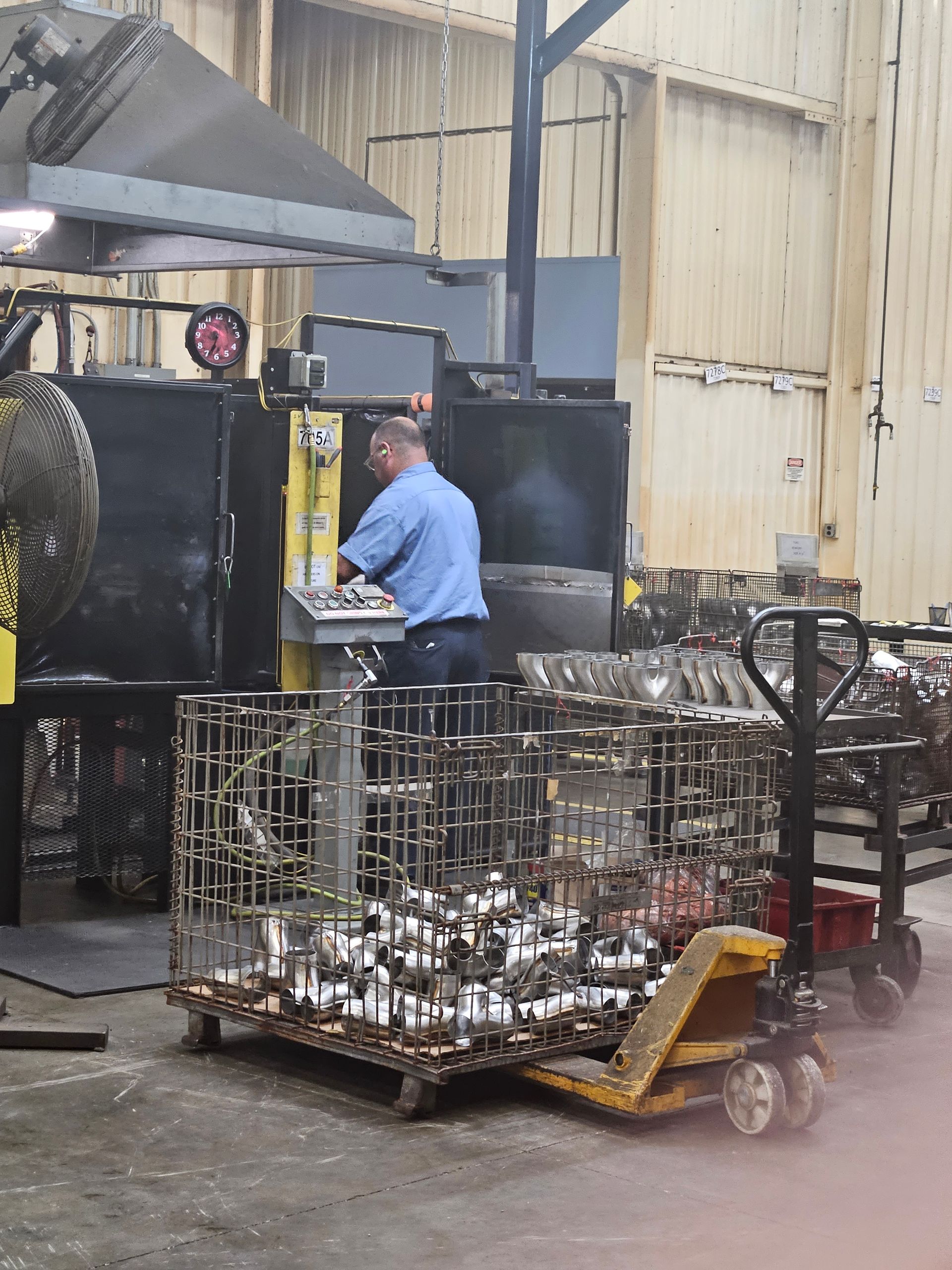 A man is working on a machine in a factory
