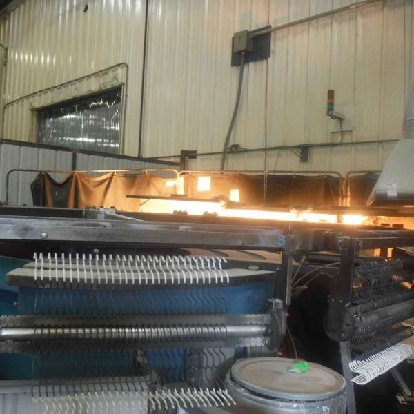 A machine in a factory has a green tag on it