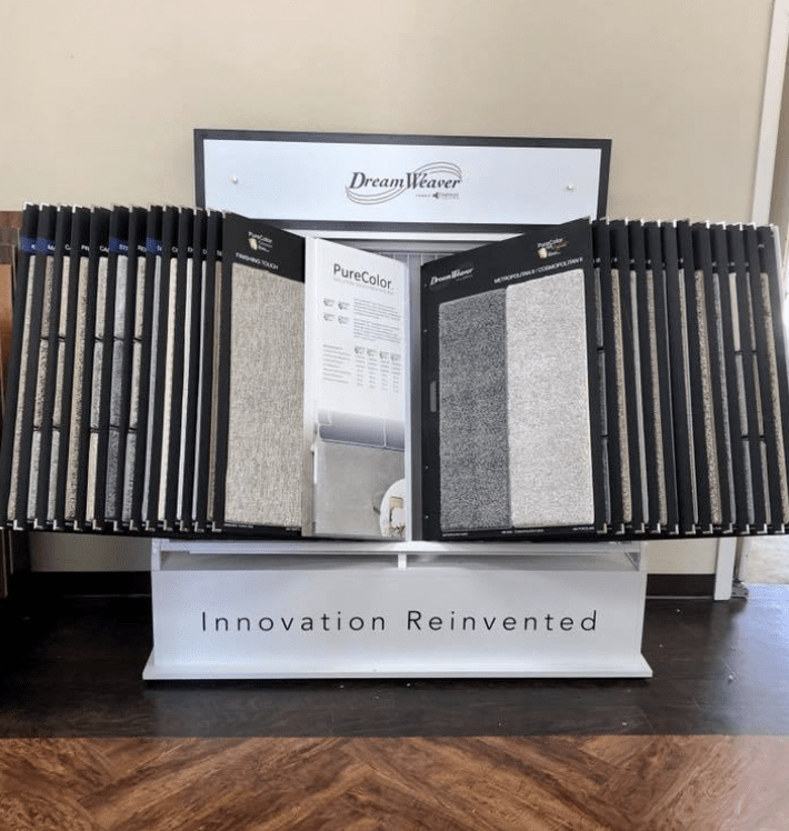 A display of carpets and a sign that says innovation reinvented