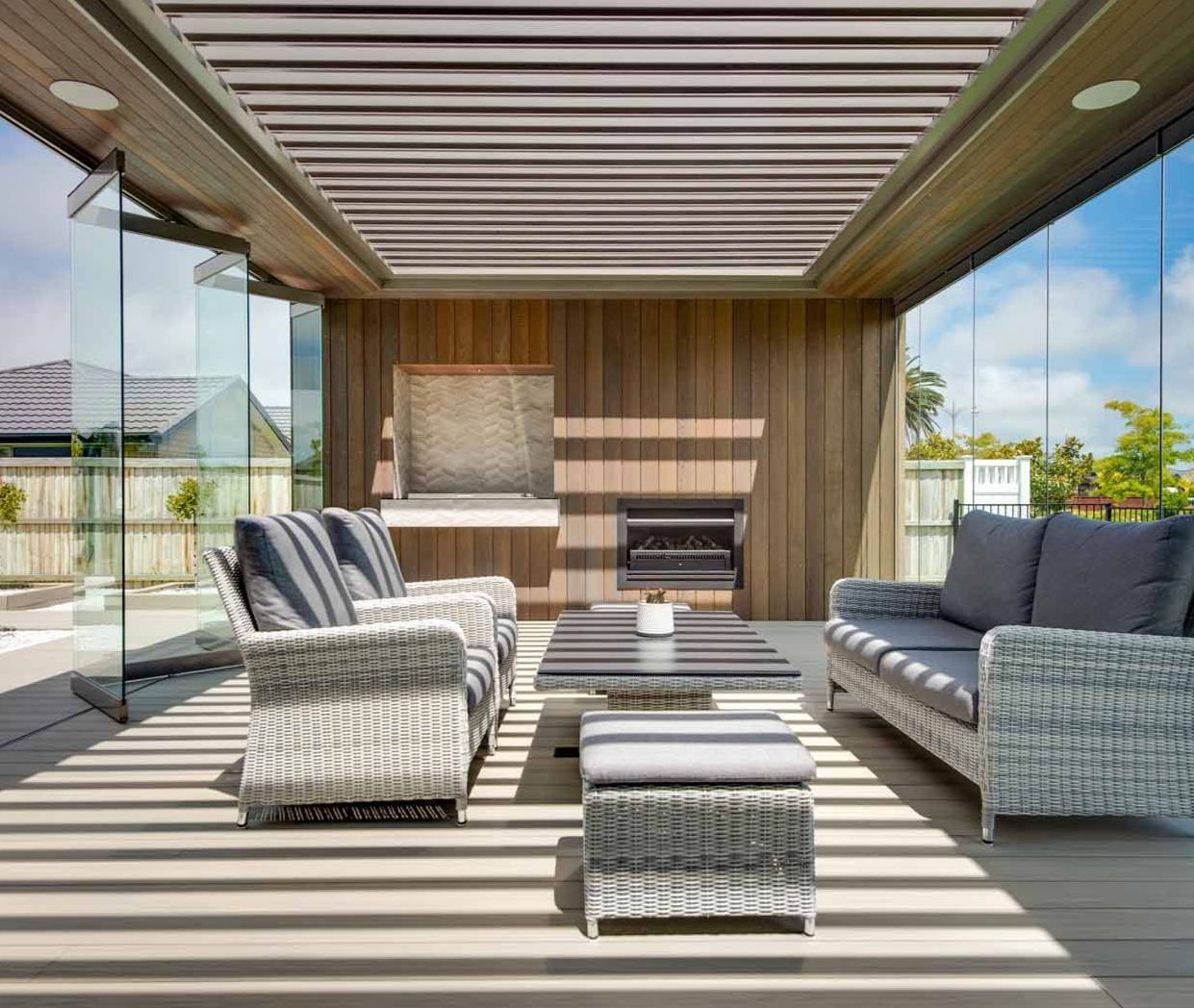 A living room with a couch , chairs , table and fireplace.