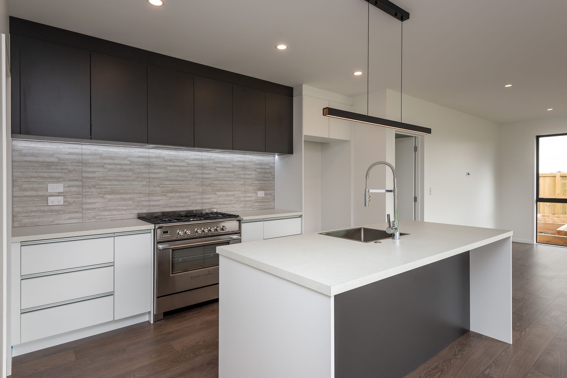 A kitchen with a large island and a stove