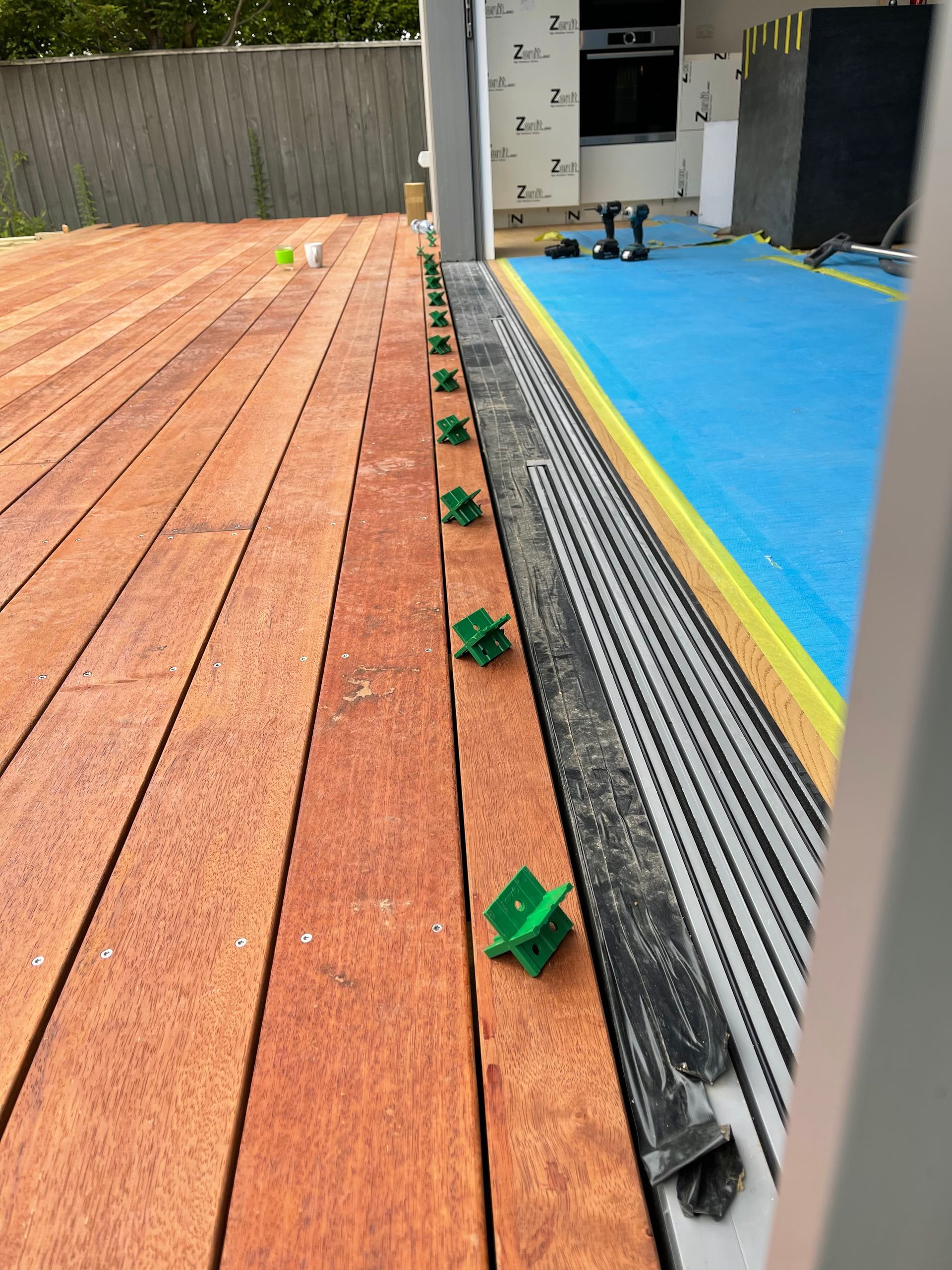 a row of green clips on a wooden deck that says z on it