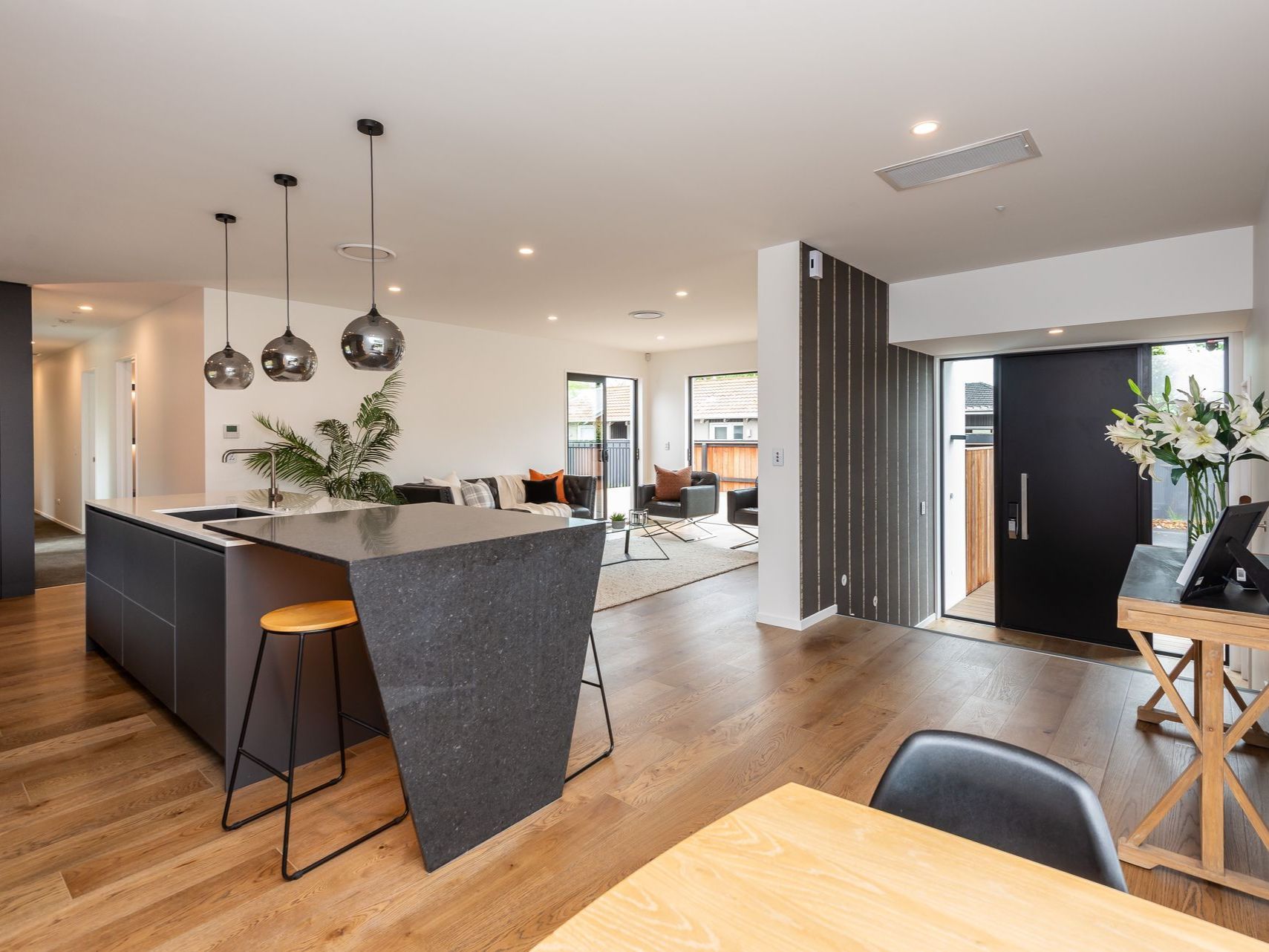 a kitchen and dining area with a black door