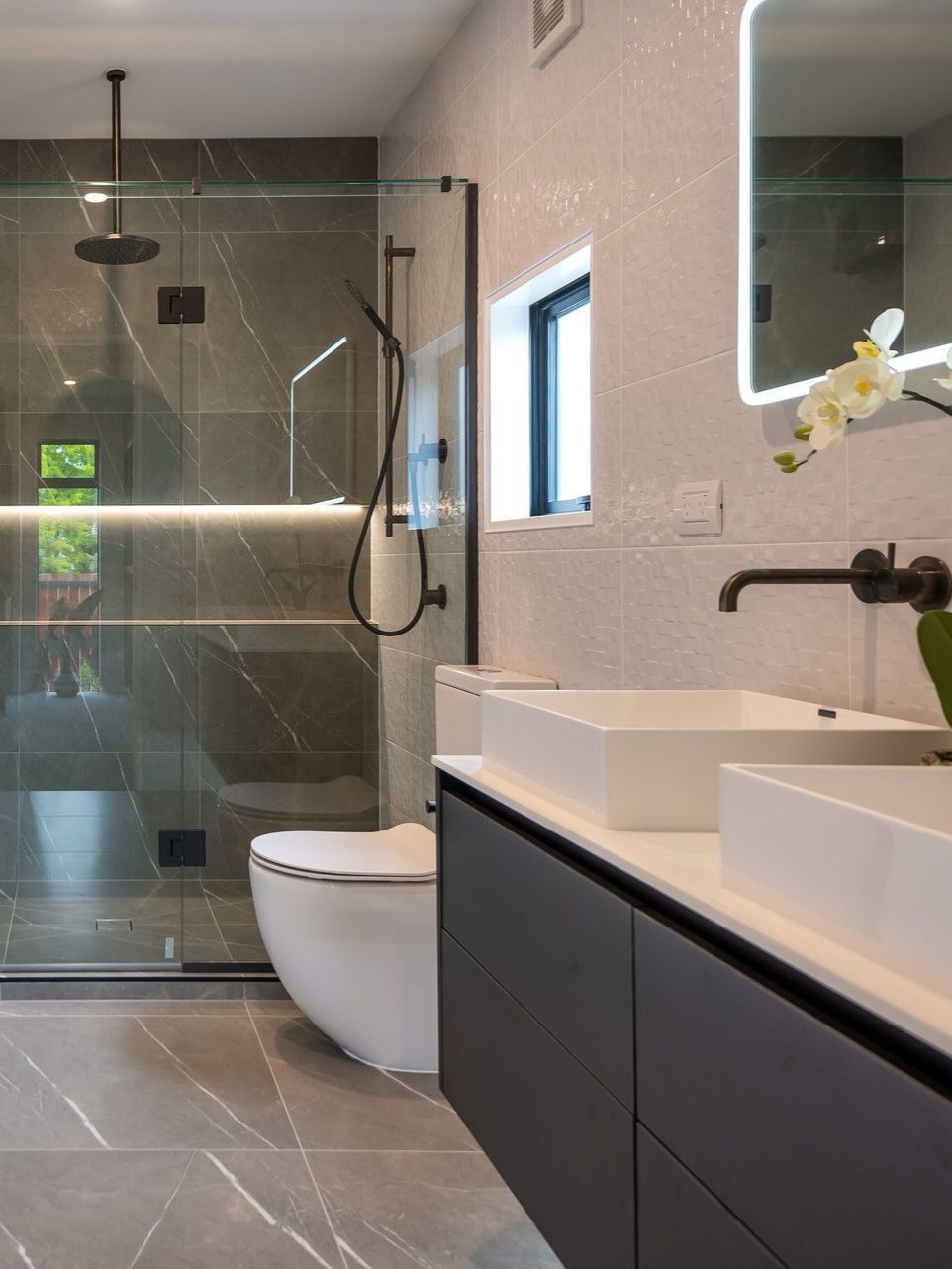 a bathroom with a toilet a sink and a shower