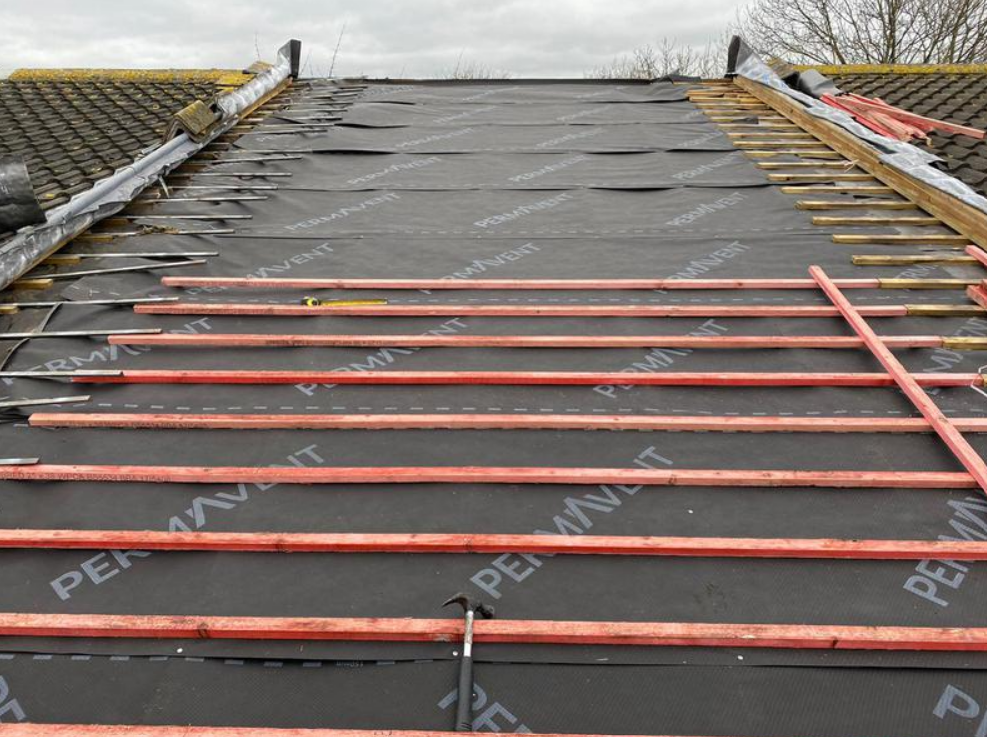 Picture of a mid terrace property undergoing a roof replacement by Roofers Nottingham