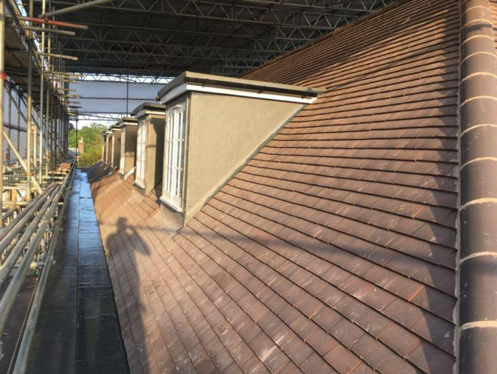 Picture of a synthetic slate roof tile on a cottage roof  by roofers Nottingham
