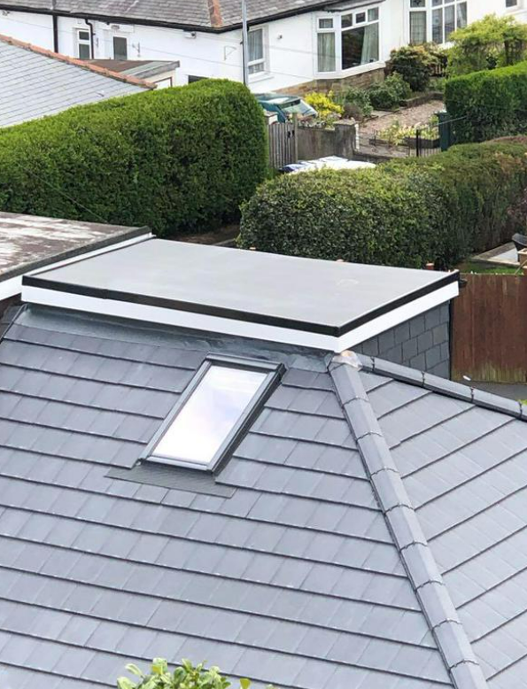 Picture of a a new grey concrete tile pitched roof and single ply flat roof extension by Roofers Nottingham
