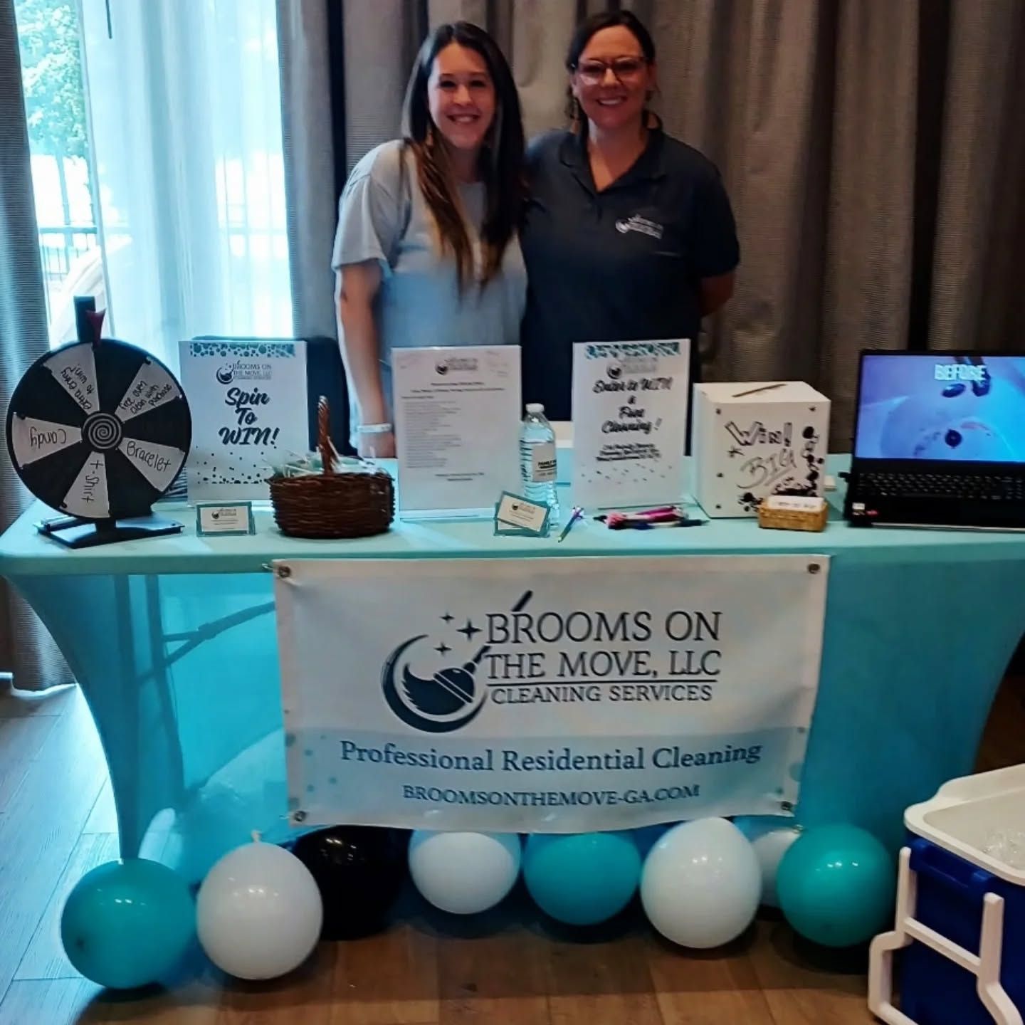 Two women at a booth promoting 