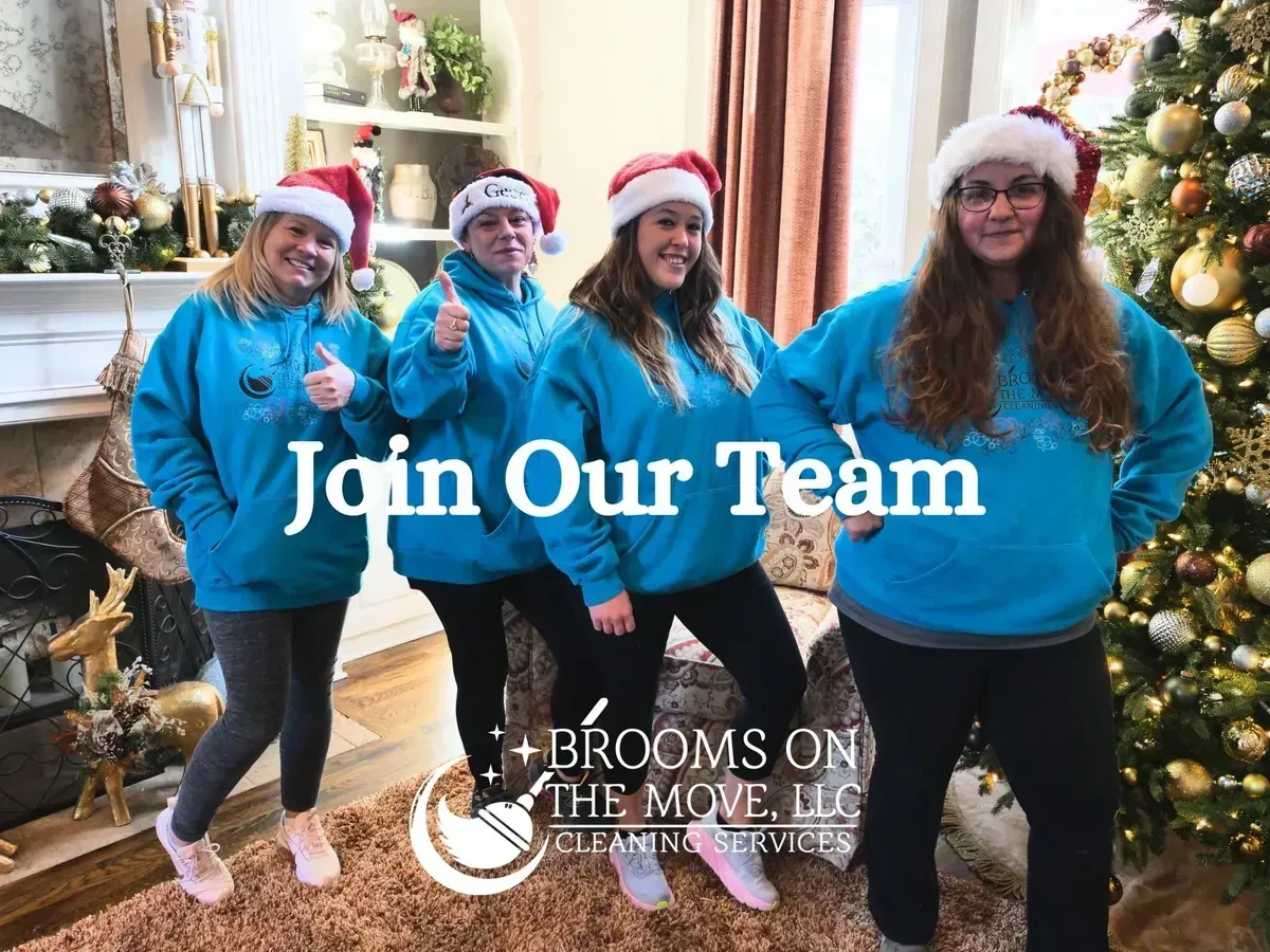Four people in Santa hats and teal sweatshirts. Text: "Join Our Team". Cleaning company logo with Christmas decor.