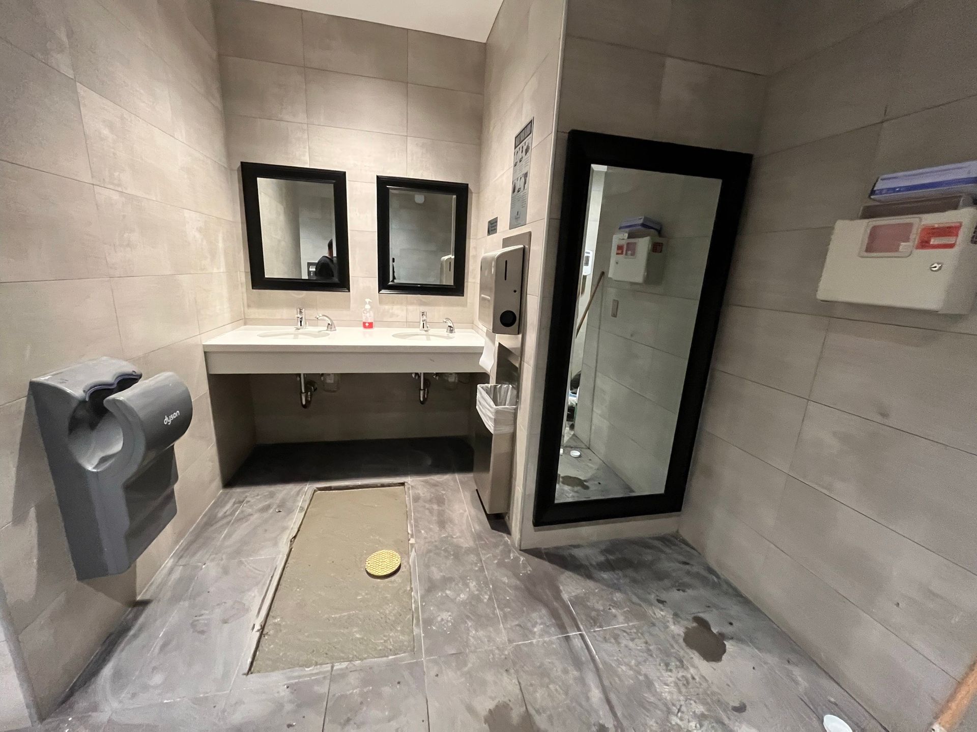 A bathroom with two sinks and a mirror.