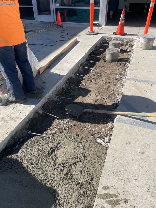 A person is digging a hole in the ground with a shovel.