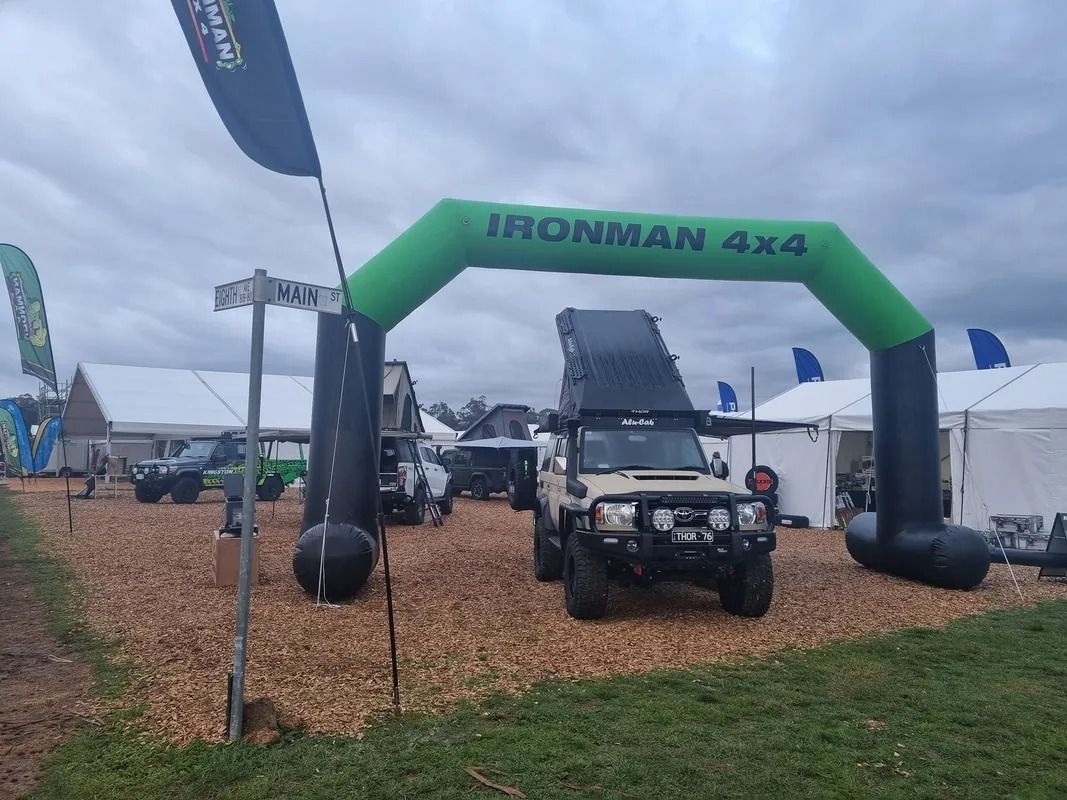 Green Irohnan 4x4 Inflatable Arch Over an Off-road Truck at an Outdoor Event — Kingston 4wd and Tyres In Huntingfield, TAS