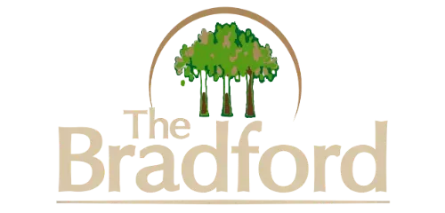 The Bradford logo with a green tree under an arch and beige text on a white background