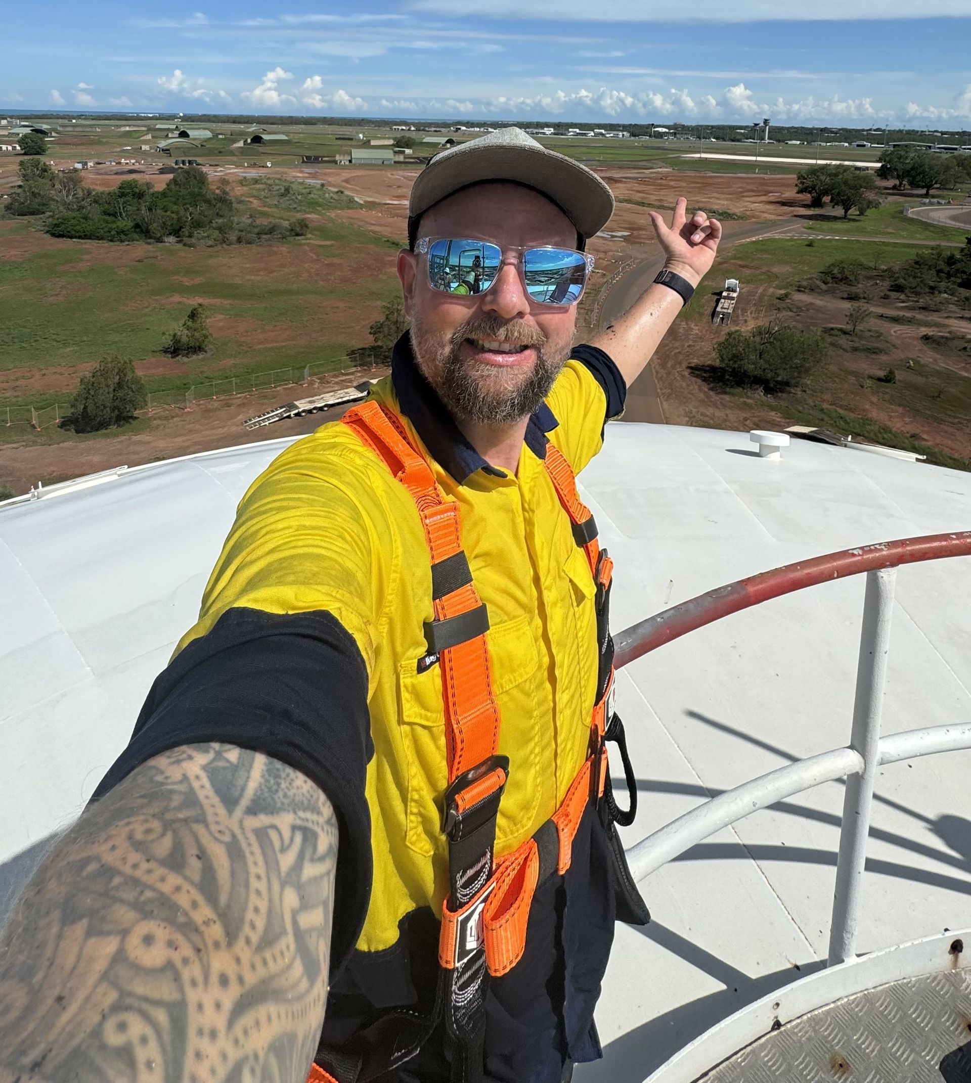 Steve Goat working on top of a remote water tank in the tropical heat. 