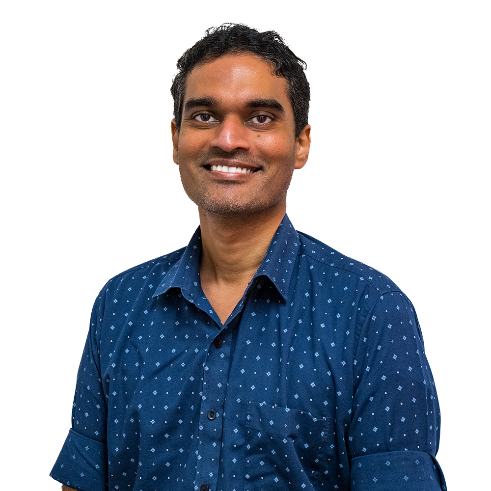 Smiling person in a blue patterned shirt against a white background
