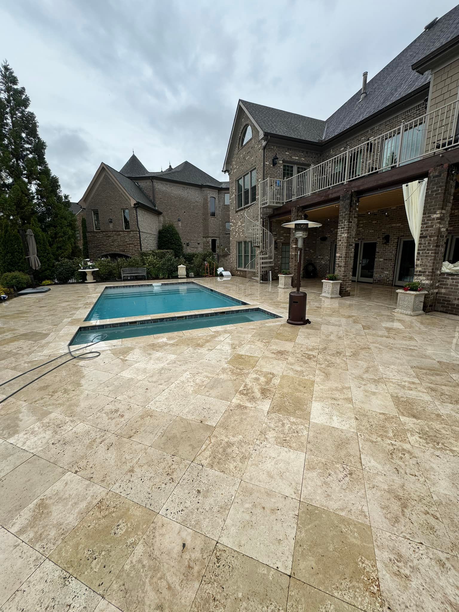 A large house with a large swimming pool in front of it.
