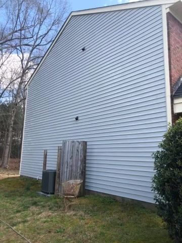 A large white house with a wooden fence in the backyard.