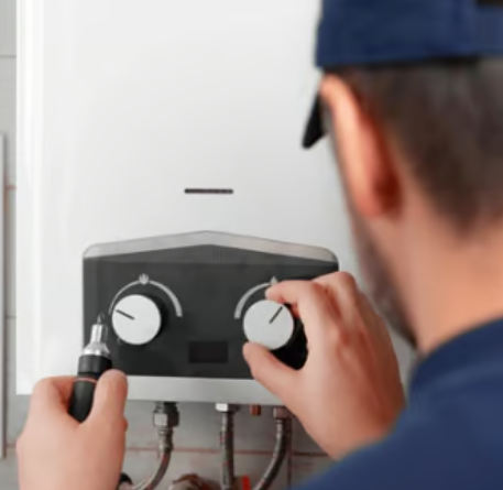 plumber is adjusting a tankless water heater
