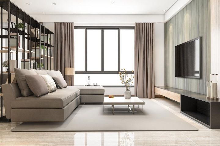 A living room with a couch , coffee table , and television.