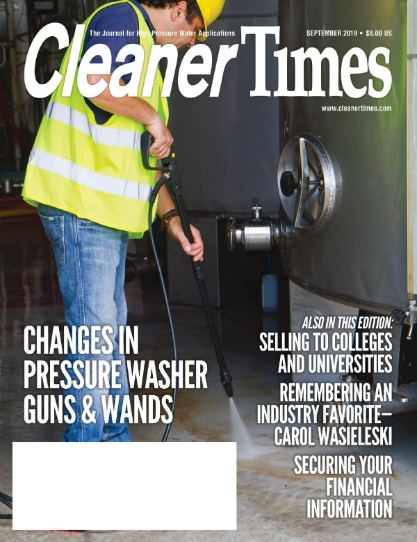Cleaner Times magazine cover showing a worker using a pressure washer on a stainless steel surface
