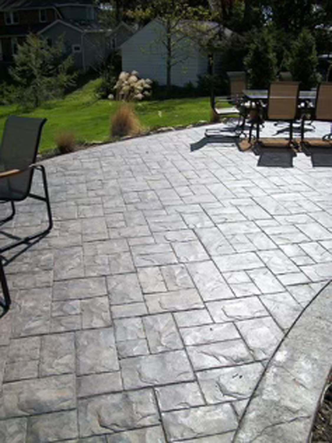 A patio with a table and chairs on it.