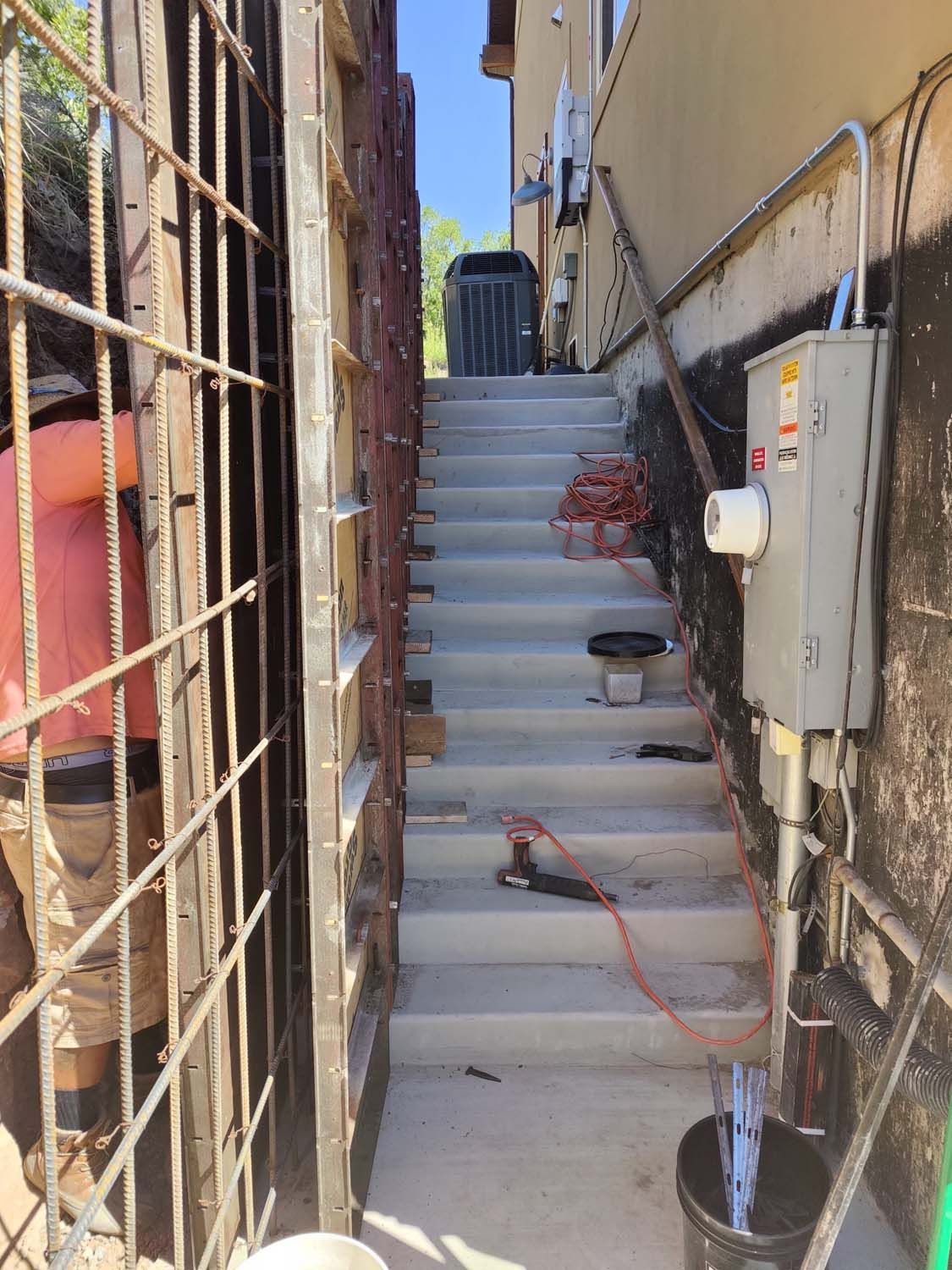 A set of stairs leading up to a building under construction.