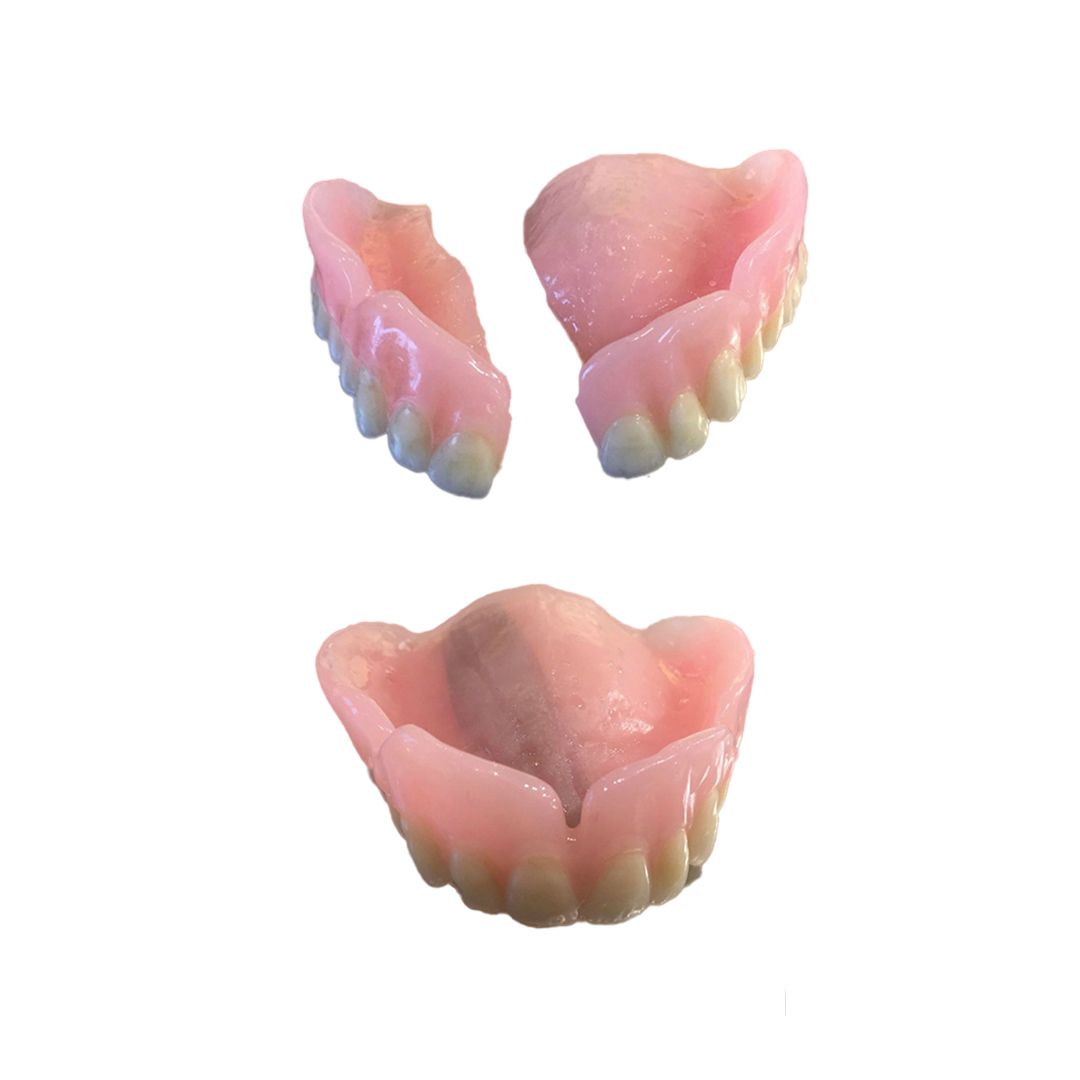 Three pink scalloped plastic dental molds, two smaller above one larger, on a white background