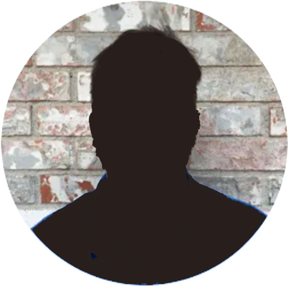 Silhouette of a person’s head and shoulders against a brick wall background