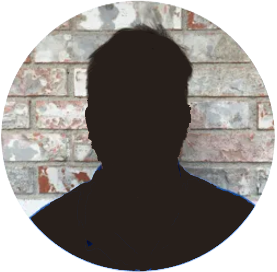 Dark silhouette of a person in front of a white and red brick wall