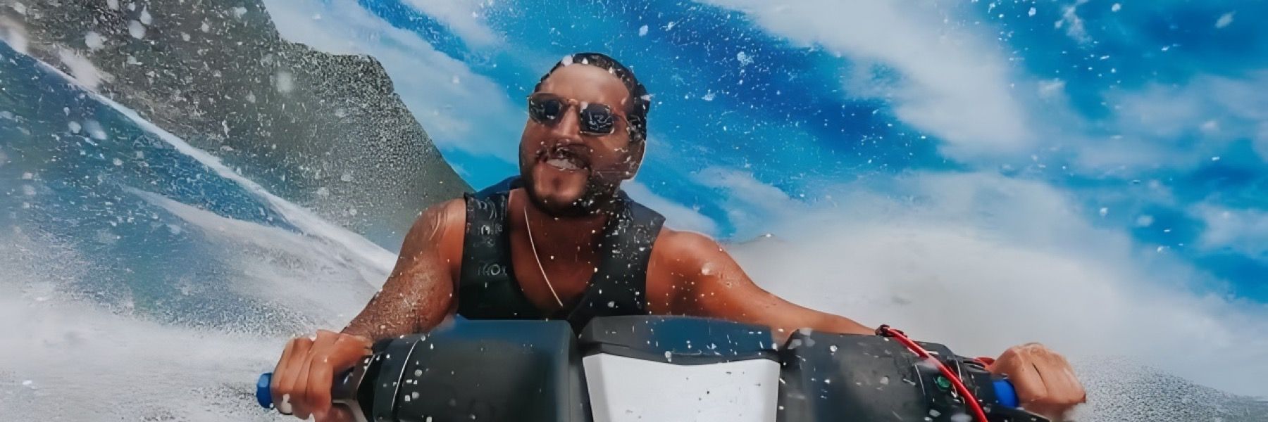 A man is riding a jet ski in the ocean.