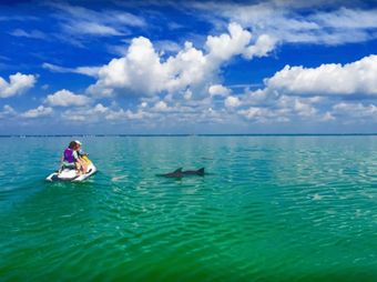 Two people are riding a jet ski on a lake.