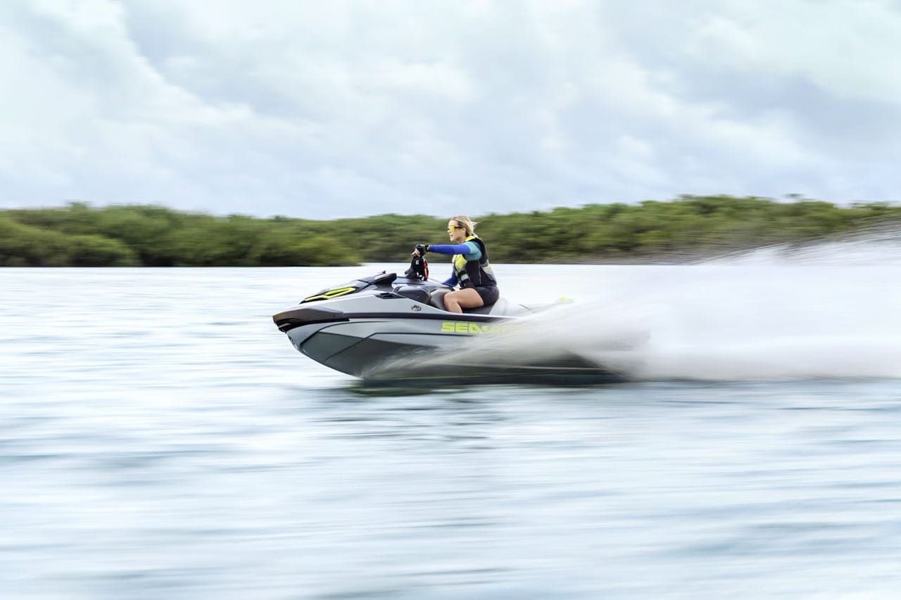 A person is riding a jet ski on a lake.