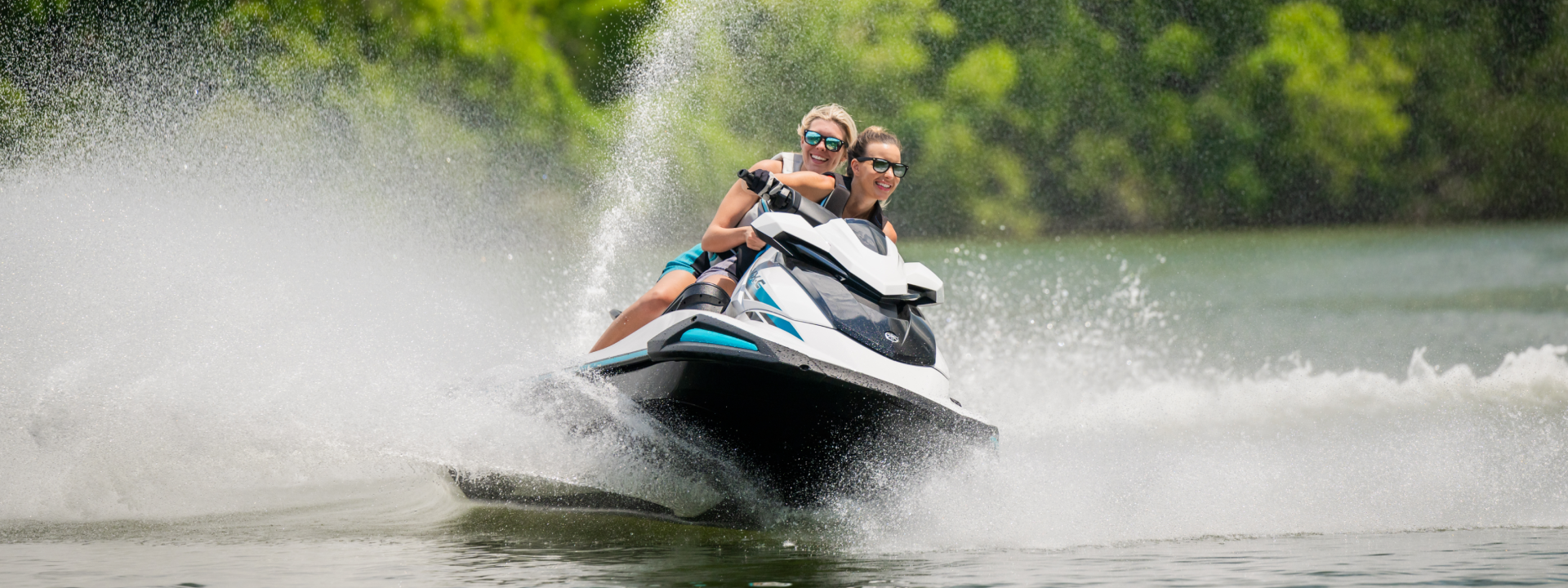 Two people are riding a jet ski on a lake.