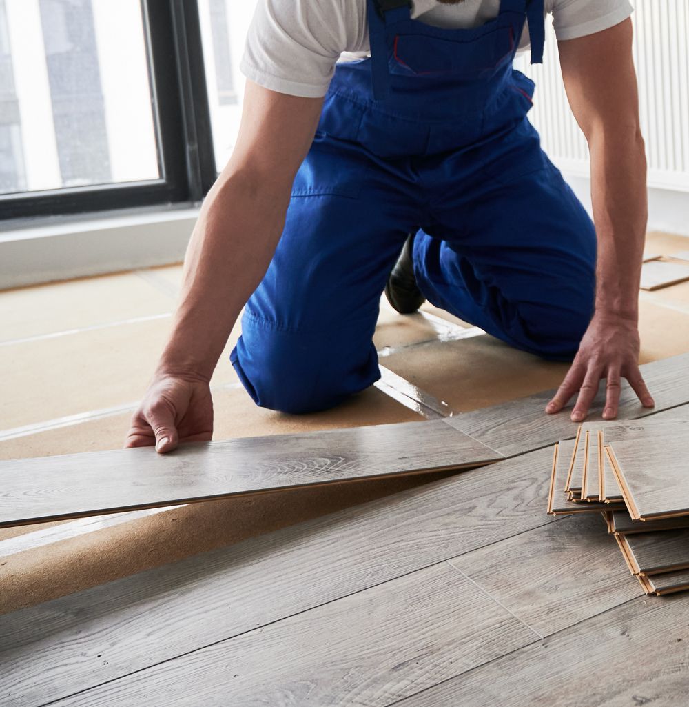 A person is cleaning a tile floor with a sponge.