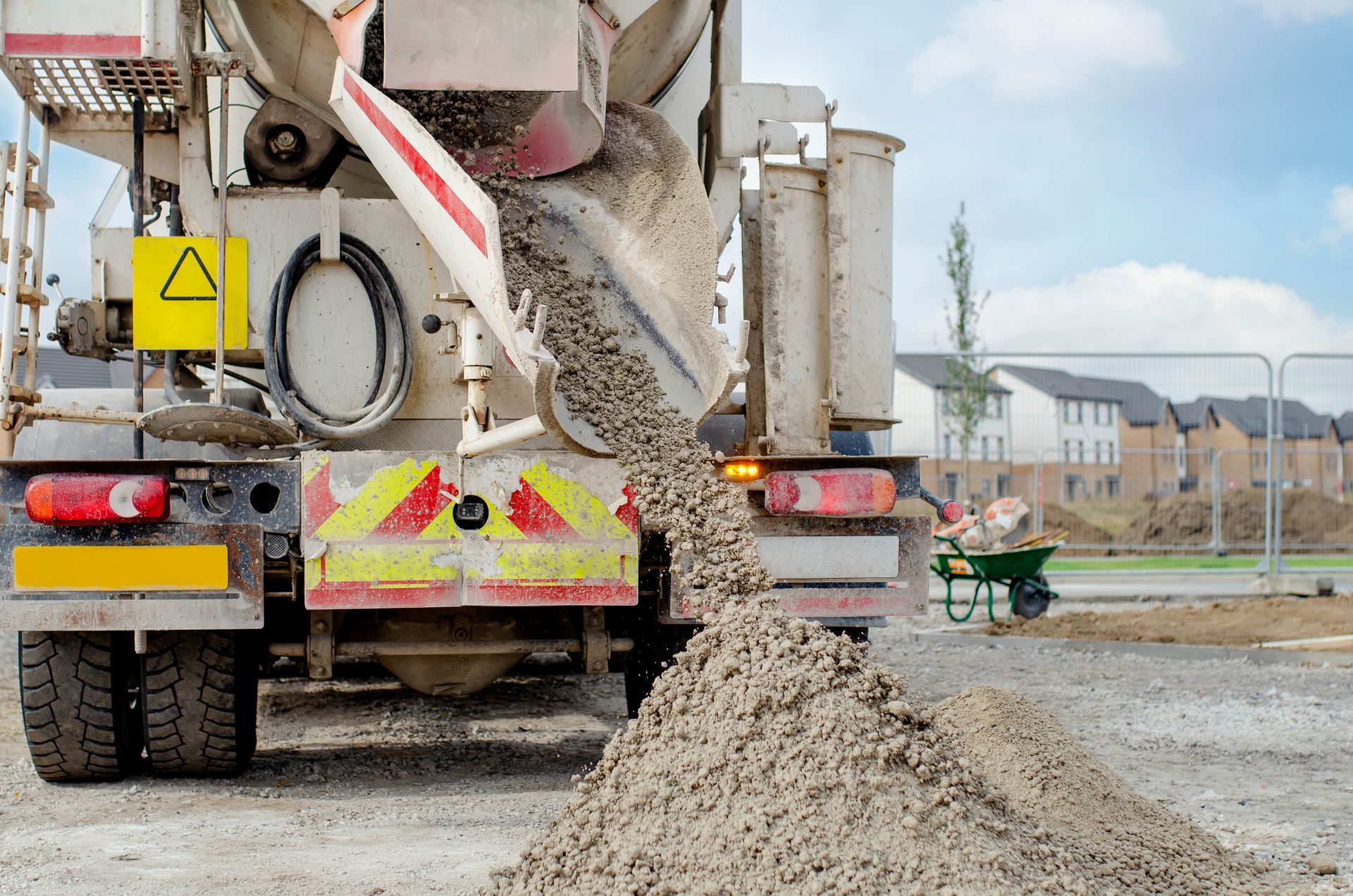 A cement truck from Hartley Ready Mix dumps cement on the ground, showcasing a reliable concrete sup