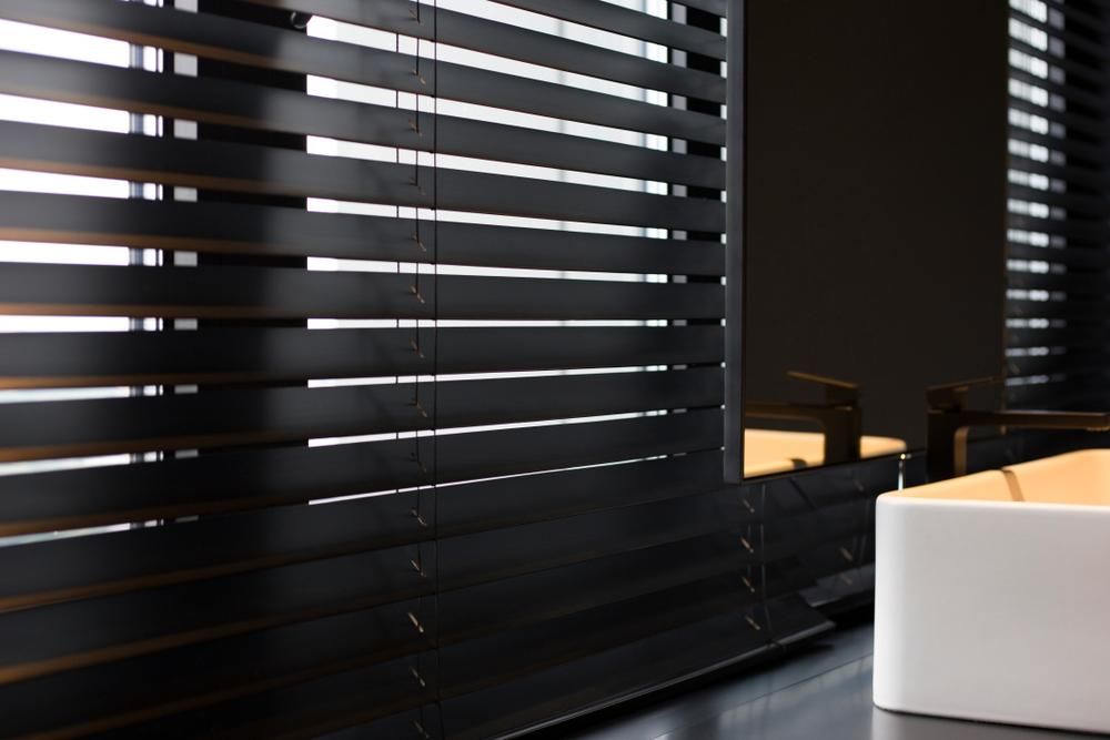 A Bathroom With Black Blinds and a White Sink — Mid Coast Flooring & Blinds In Forster, NSW