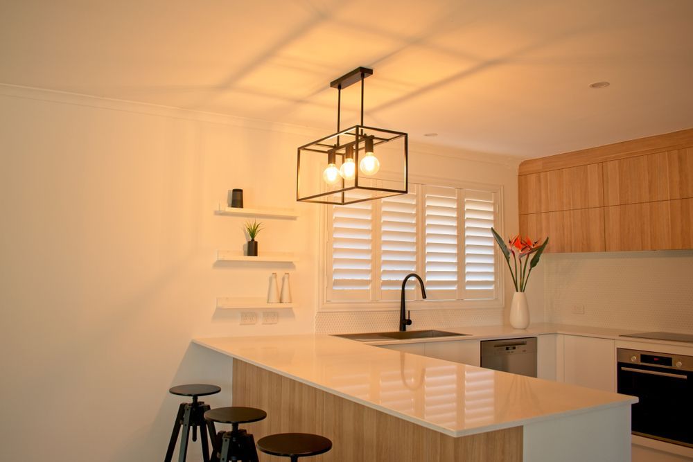 A Kitchen With A Pendant Light Hanging From The Ceiling And A Sink — Mid Coast Flooring & Blinds In Laurieton, NSW
