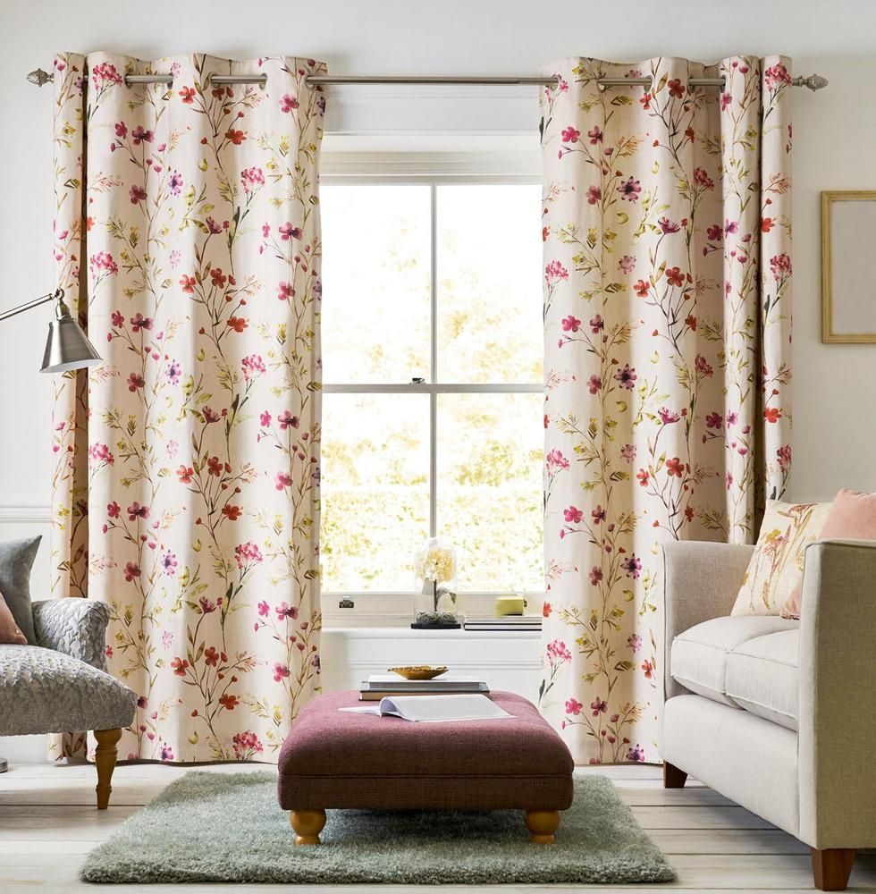 A Living Room With a Couch Ottoman and Floral Curtains — Mid Coast Flooring & Blinds In Taree, NSW