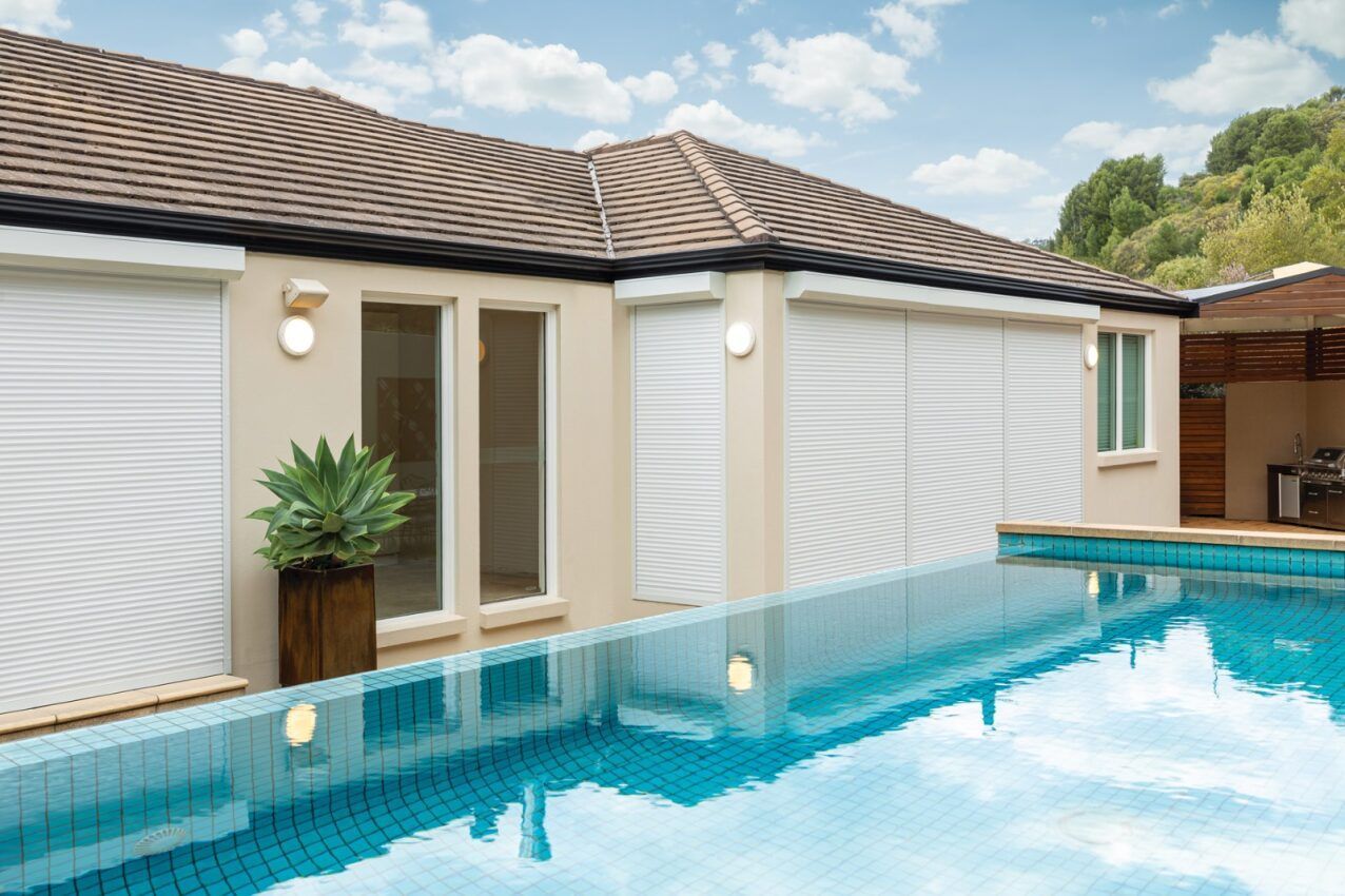 A House With A Swimming Pool In Front Of It — Mid Coast Flooring & Blinds In Taree, NSW