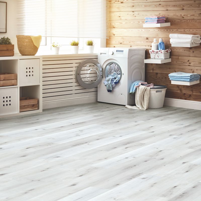A Laundry Room With A Washing Machine And A Basket Of Clothes — Mid Coast Flooring & Blinds In Laurieton, NSW