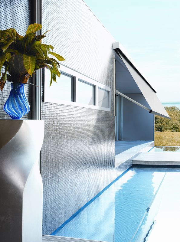 A Blue Vase Sits Next To A Swimming Pool — Mid Coast Flooring & Blinds In Harrington, NSW
