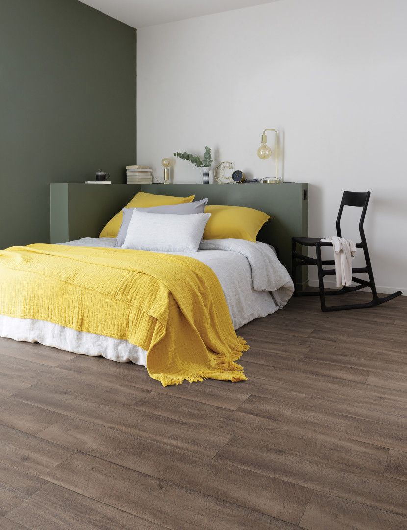 A Bed Is Sitting In A Bedroom Next To A Window — Mid Coast Flooring & Blinds In Taree, NSW